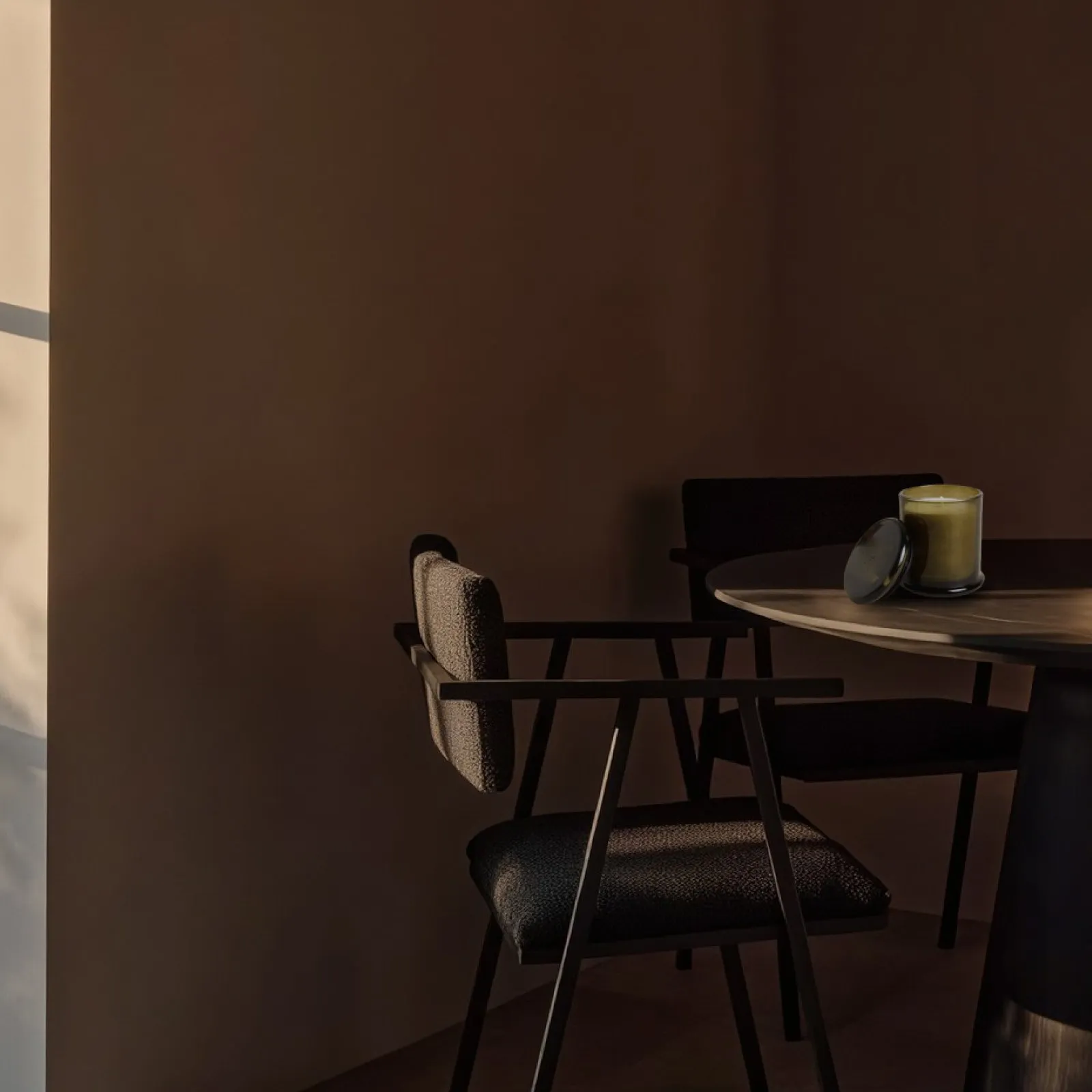 The candle in a quiet, dark resort interior